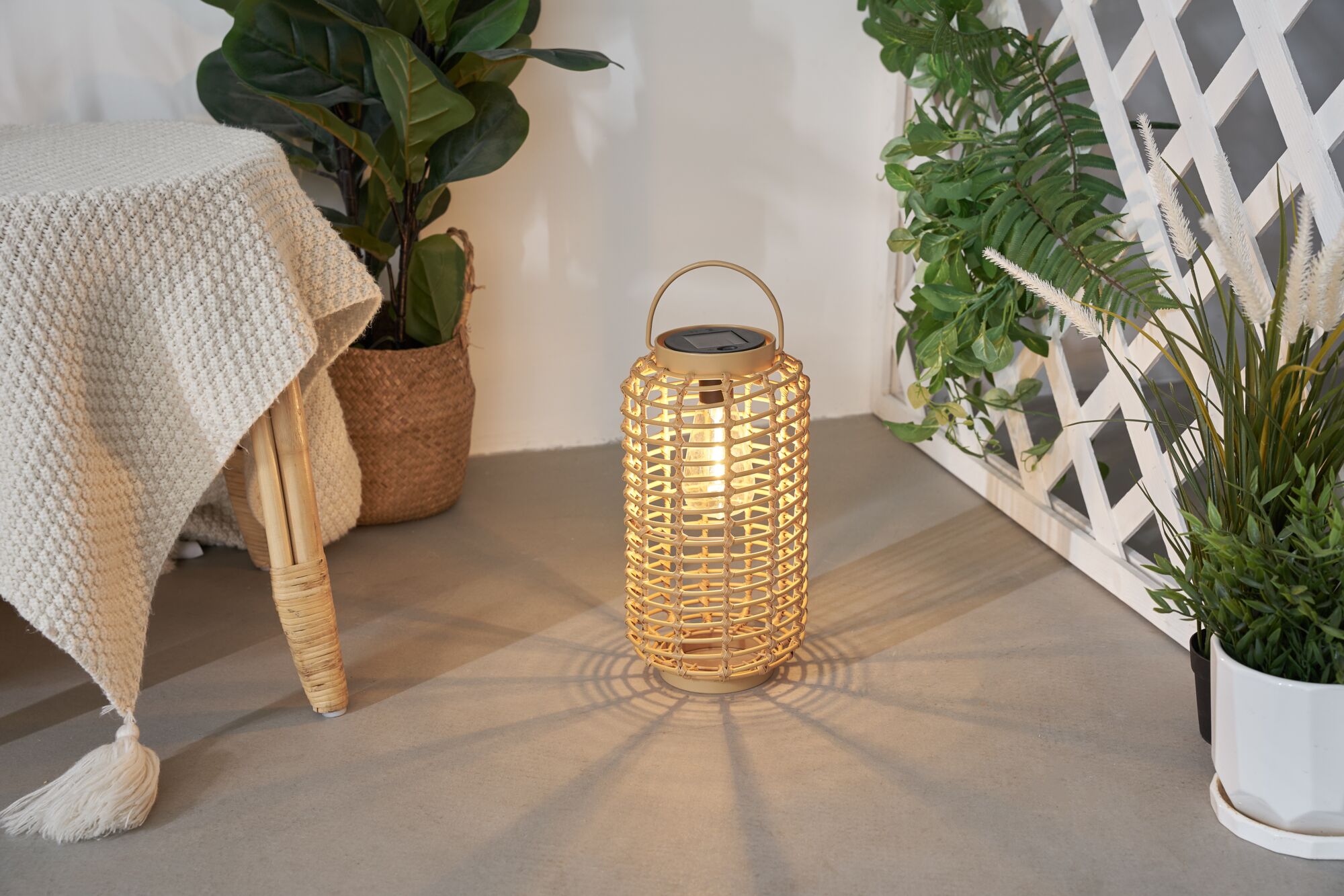Illuminated beige woven natural material lantern with solar panel for decorative garden lighting