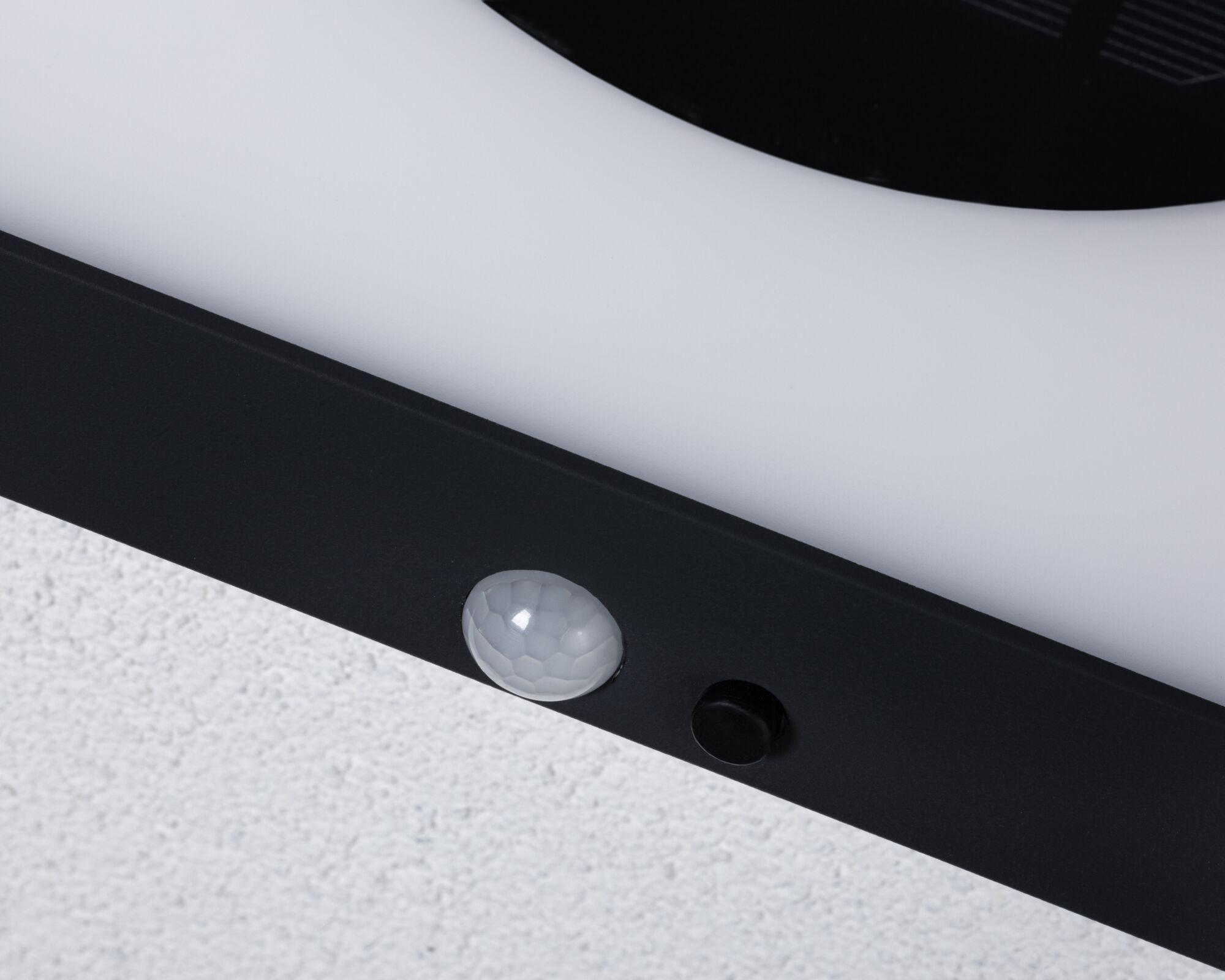 Close-up of white plastic part with black frame and sensor for LED lighting fixture