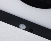 Close-up of white plastic part with black frame and sensor for LED lighting fixture