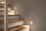 Modern white LED stair lights on wooden steps for safe and stylish home lighting