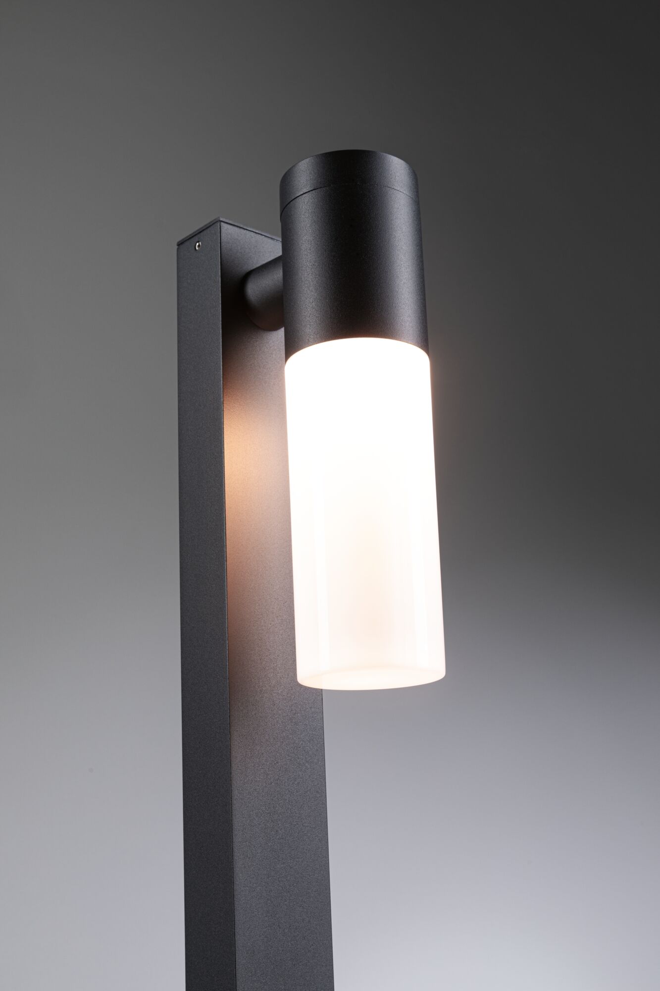 Modern black metal outdoor wall light with white glass and LED lighting for garden and terrace