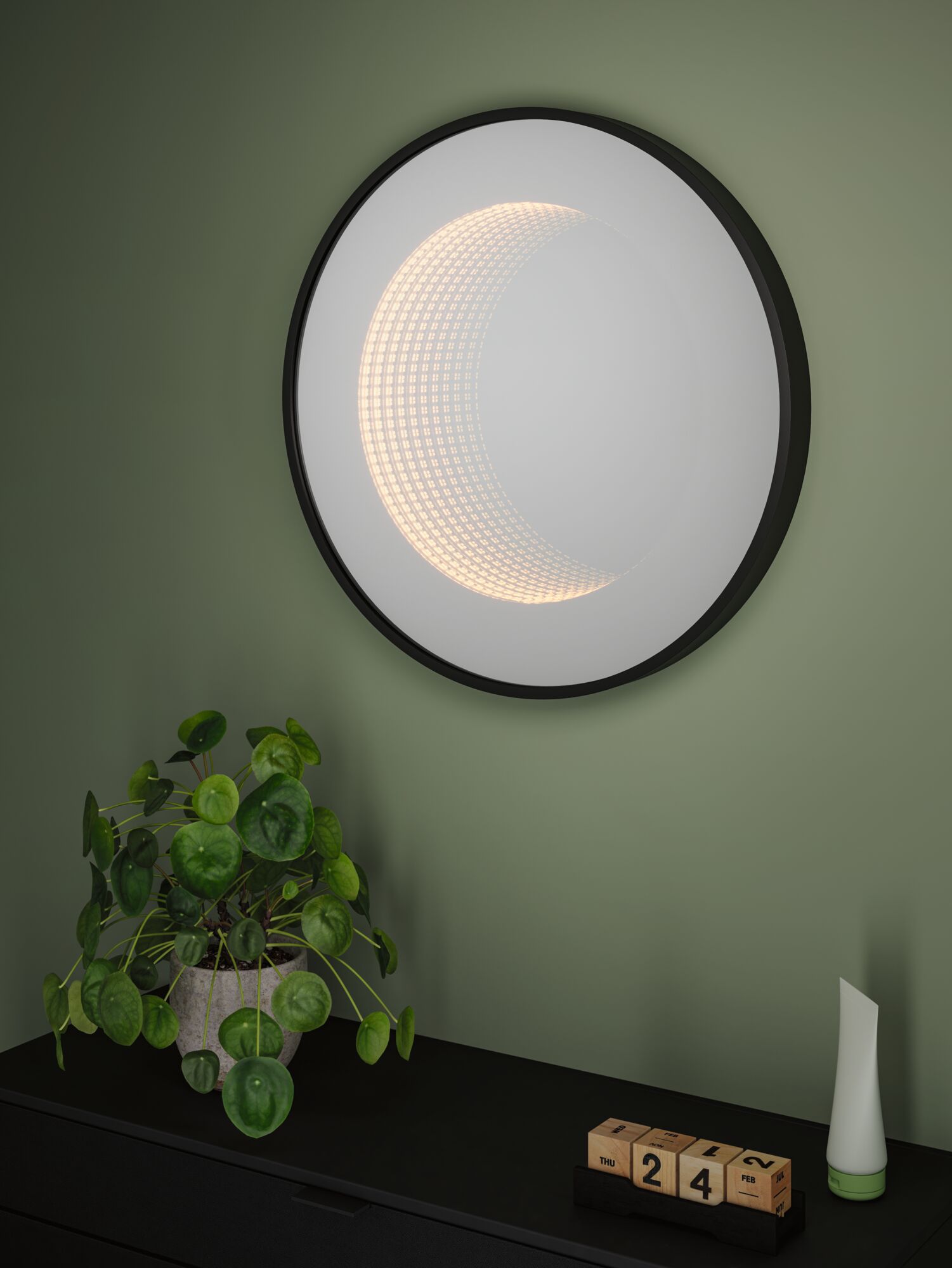 Round LED wall light with black frame and warm white light in modern room with plant and calendar.