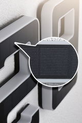 Close-up of grey plastic frame with black solar panel for energy-saving lighting solutions