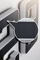 Close-up of grey plastic frame with black solar panel for energy-saving lighting solutions