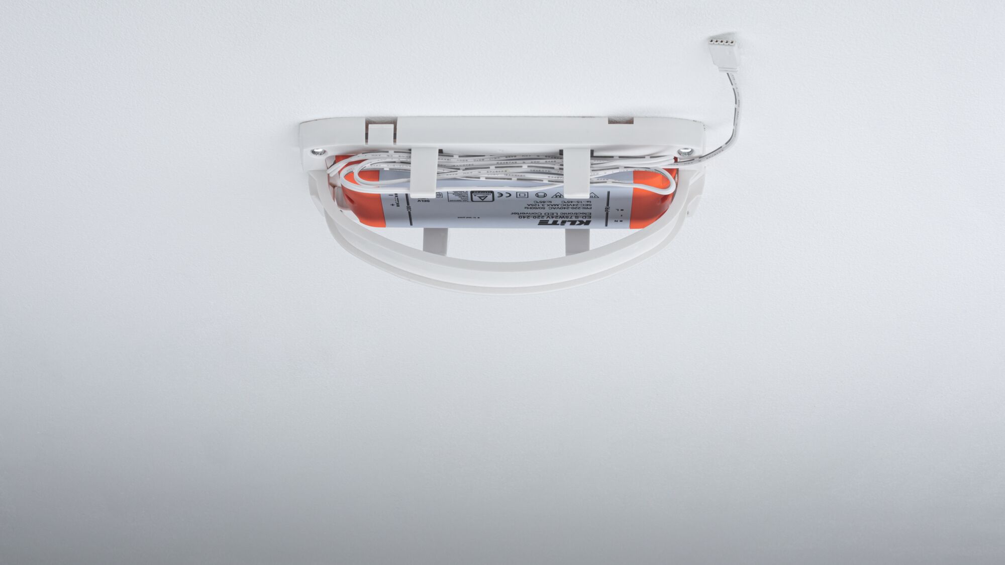 White LED emergency light with built-in battery and cables mounted on ceiling for safety lighting