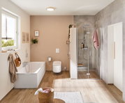 Modern bathroom with white bathtub, beige wall, glass shower with wooden bench and pink towel
