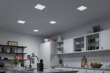 Modern kitchen with white cabinets and five square LED ceiling lights providing bright room lighting.