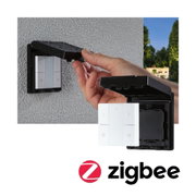 Waterproof black cover protecting white Zigbee wall switch outdoors with hand lifting lid