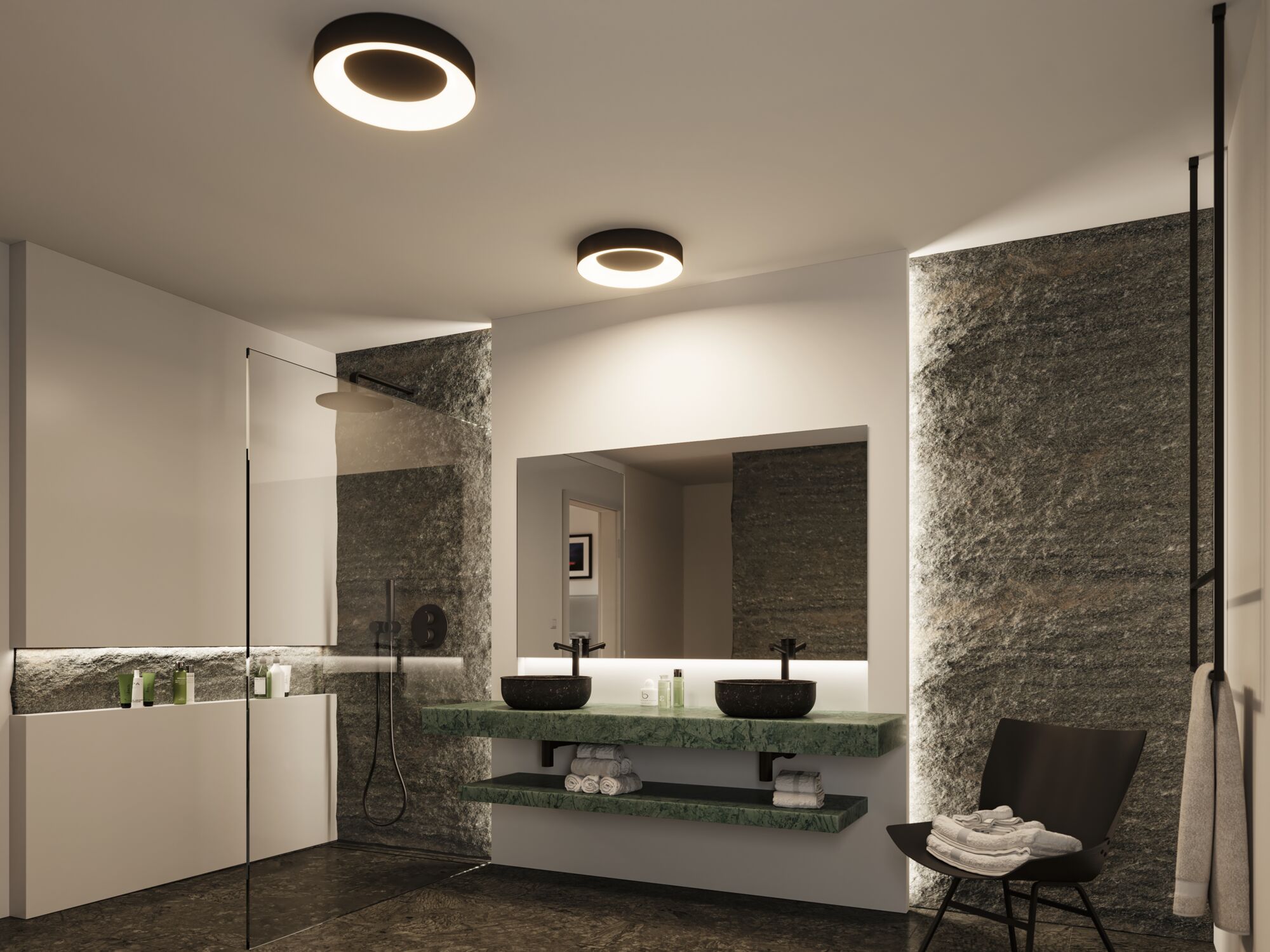 Salle de bain moderne avec plan vasque en marbre vert, lavabos noirs et plafonniers ronds.