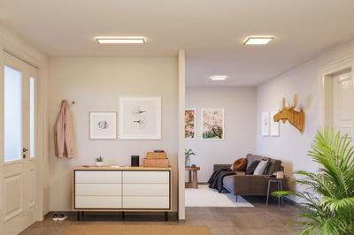 Modernes Wohnzimmer mit quadratischen Deckenleuchten in warmweißem Licht und skandinavischem Design