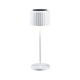 White table lamp with ribbed shade and round metal base for modern interior lighting