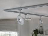 Modern ceiling light with three silver LED spotlights on track system for living spaces.