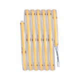 Flexible LED strip light with warm white glow and transparent silicone coating for versatile lighting use.