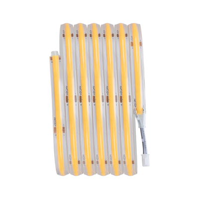 Flexible LED strip light with warm white glow and transparent silicone coating for versatile lighting use.