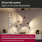 Black ULine Belt System with red cables hanging from ceiling for customizable room lighting and accents.