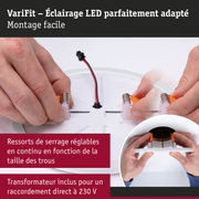 Mains assemblant un spot LED blanc avec ressorts réglables et connexion câble 230 V