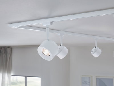 Three white metal LED track spotlights mounted on ceiling for modern room lighting
