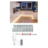 Warm white LED strip light with remote and power supply, perfect for kitchen lighting and ambient illumination.