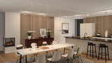 Modern white pendant lights above dining table in open kitchen with wood and black accents