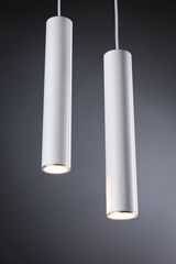 Two white cylindrical metal LED pendant lights with warm white light for modern interior lighting