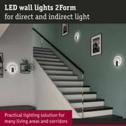 Modern white and black LED wall lights 2Form providing direct and indirect lighting in stairwell