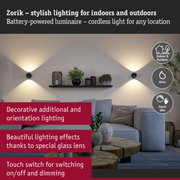 Zorik black battery-powered wall light with warm white glow for indoor and outdoor use