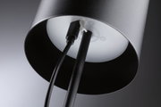 Black metal floor lamp with cable connection and white diffuser for modern living spaces.