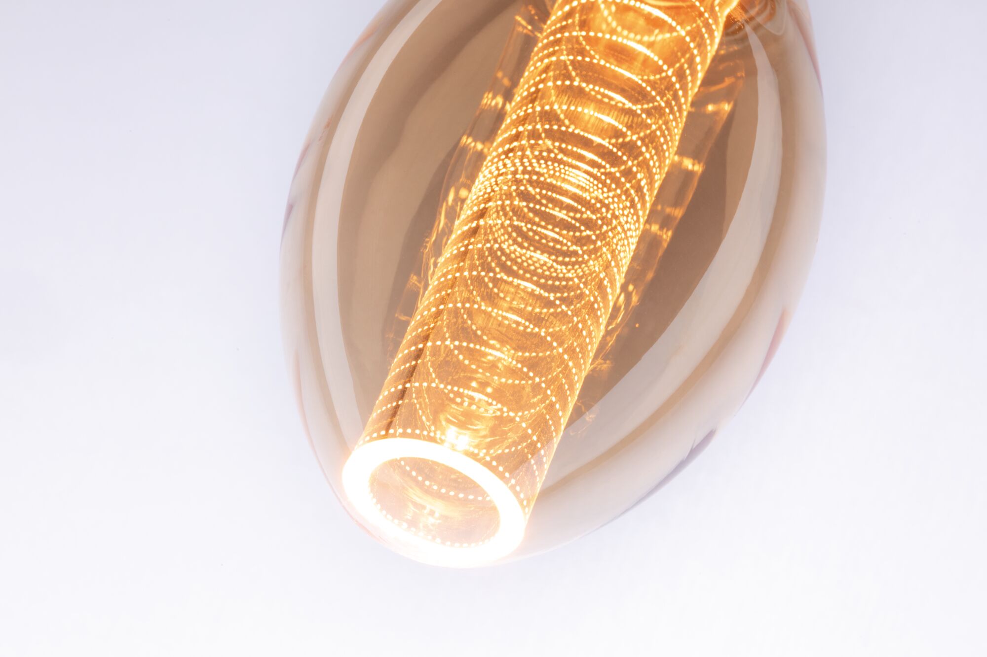Warm glowing LED bulb with golden glass and decorative light pattern for ambient home lighting