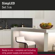 Modern white kitchen island with illuminated counter and transparent bar stool in minimalist style