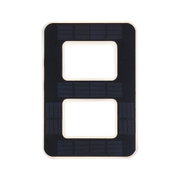 Black solar panel with rectangular cutouts and white frame for sustainable energy use.