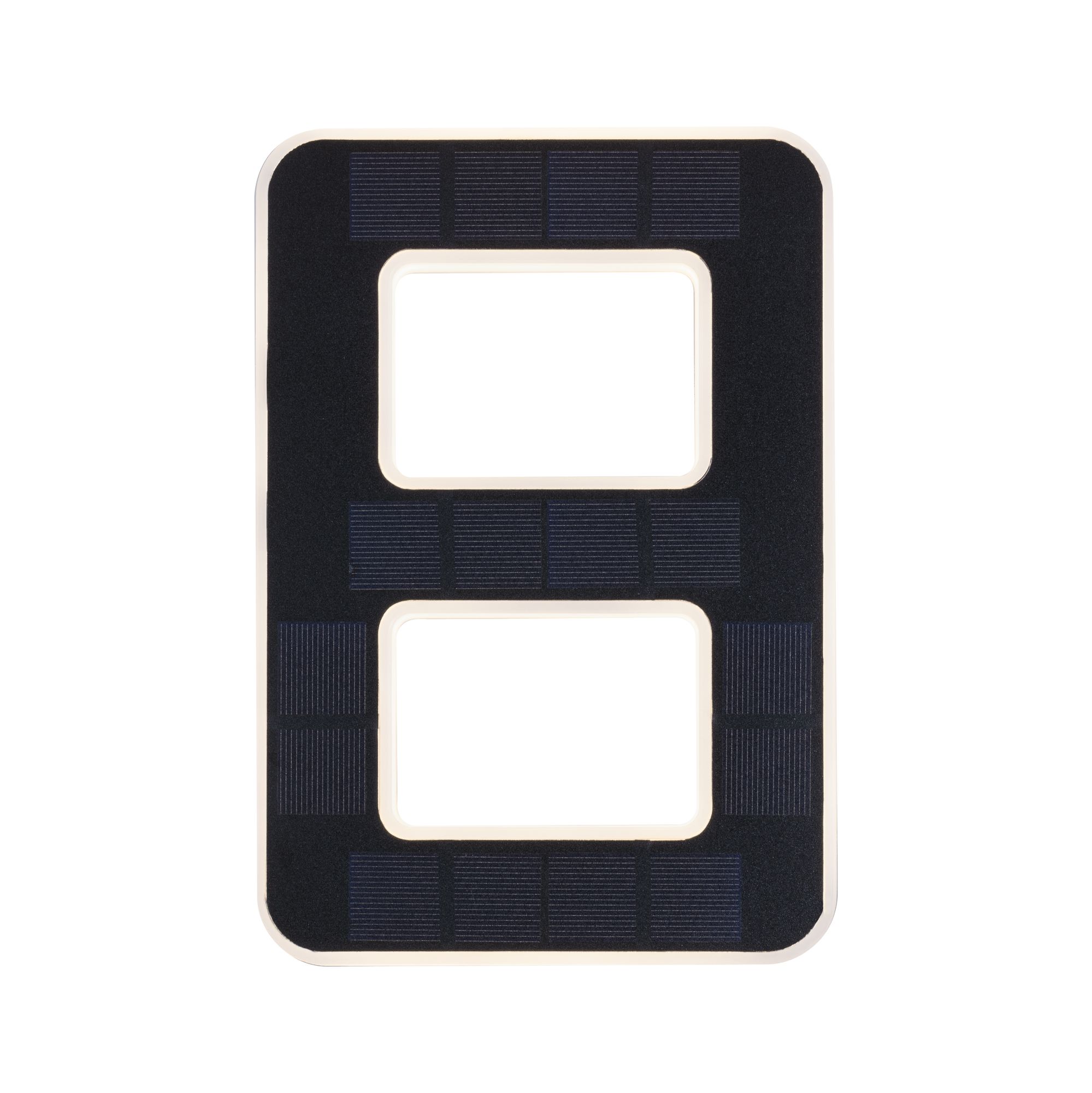 Black solar panel with rectangular cutouts and white frame for sustainable energy use.