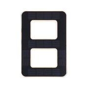Black solar panel with rectangular cutouts and white frame for sustainable energy use.