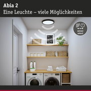 Runde Deckenleuchte in Schwarz mit Sensorfunktion über Waschmaschine und Regalen im Waschraum