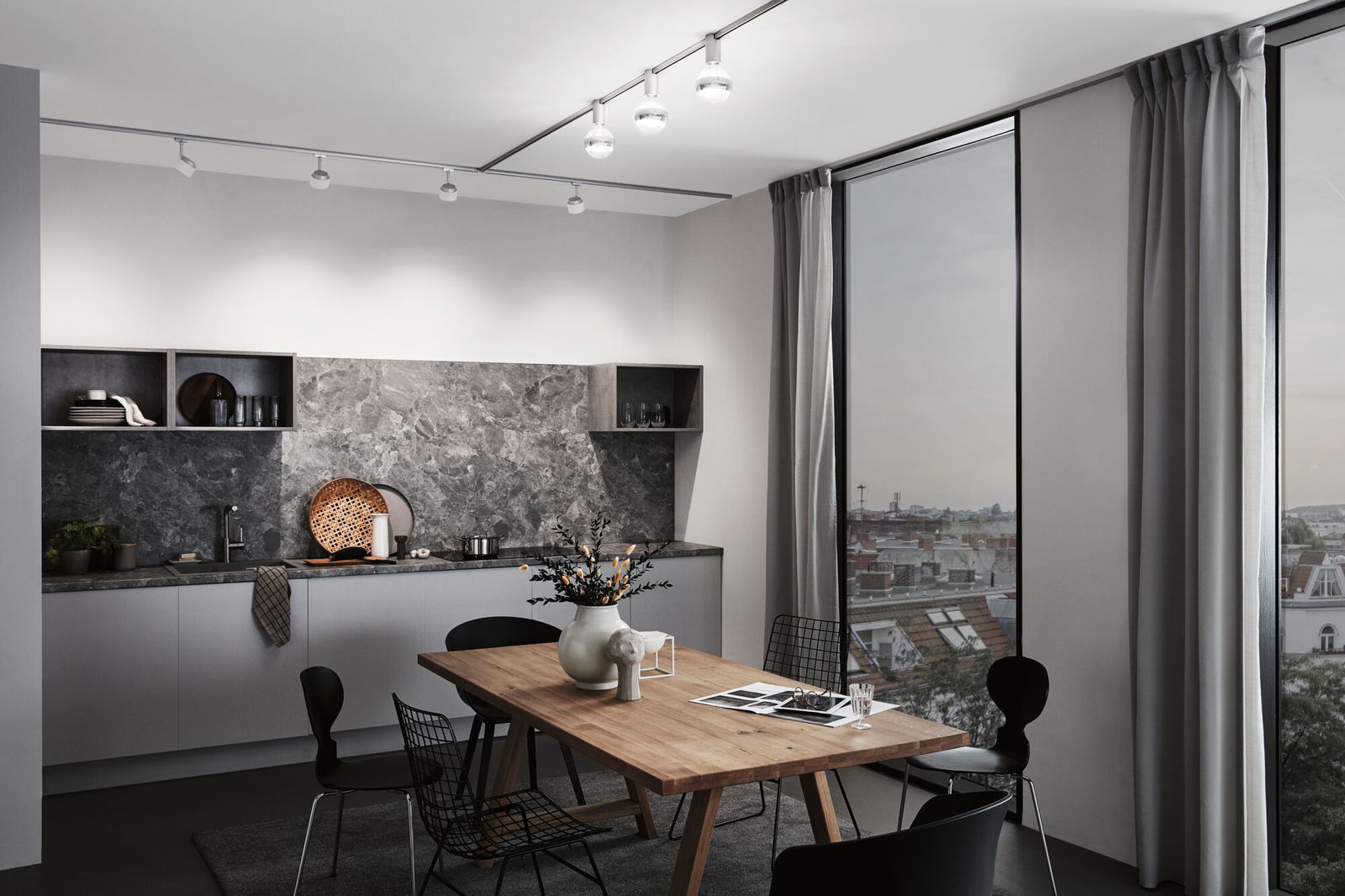 Modern kitchen with grey marble backsplash and wooden dining table under white ceiling spotlights
