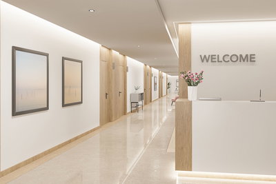 Modern reception area with LED ceiling lights, wood accents, bright floor, and minimalist decor for office lighting