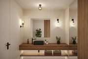 Salle de bain moderne avec lavabo noir, plan de travail en bois et appliques murales en verre transparent