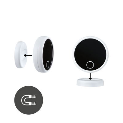 White round LED light with black surface and magnetic mount for versatile installation