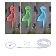 Lampe néon en forme de canard changeant de couleur rouge, vert et bleu sur mur gris avec cartes postales