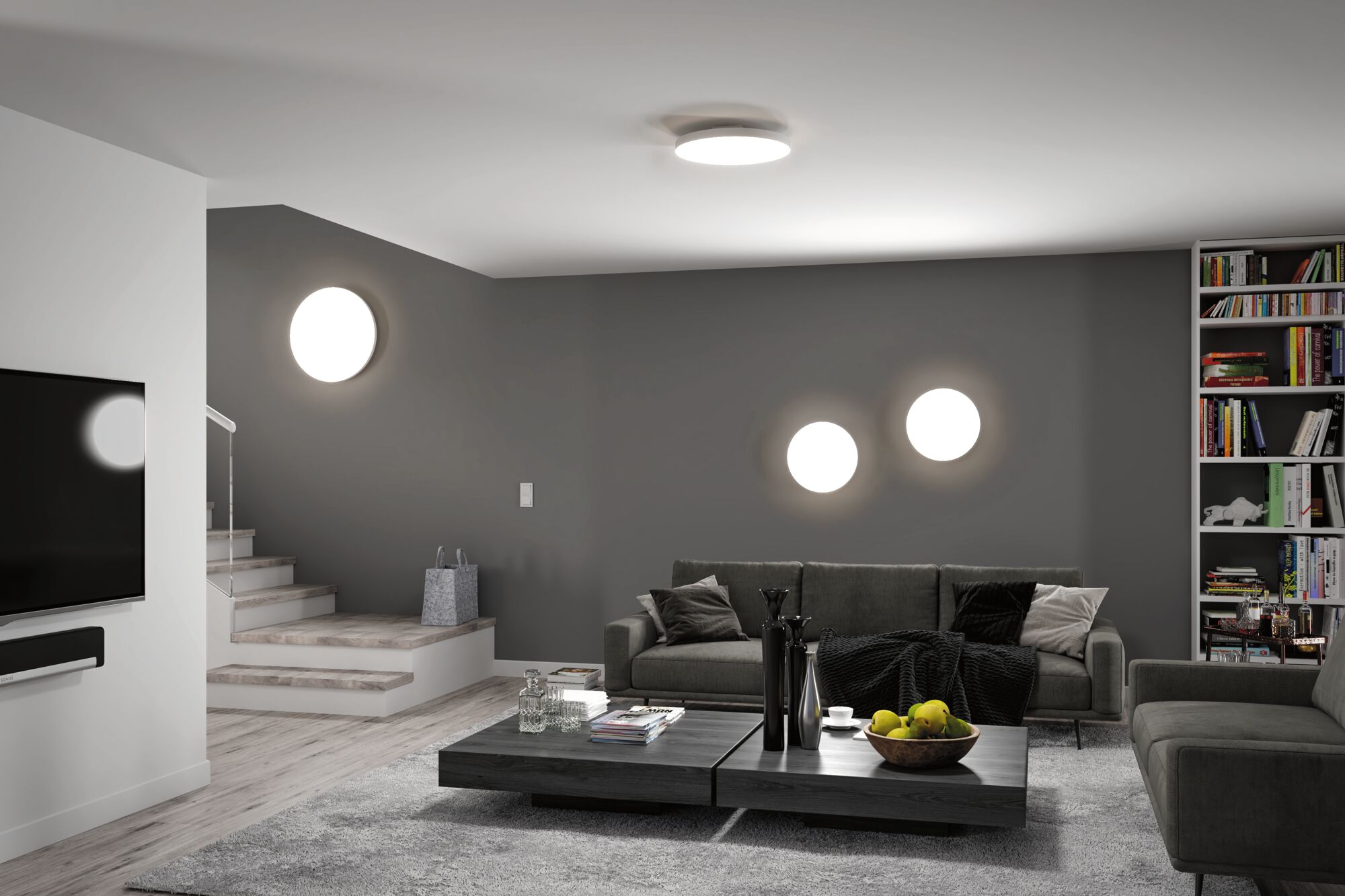 Modern living room with round white LED ceiling and wall lights on grey wall and grey sofa
