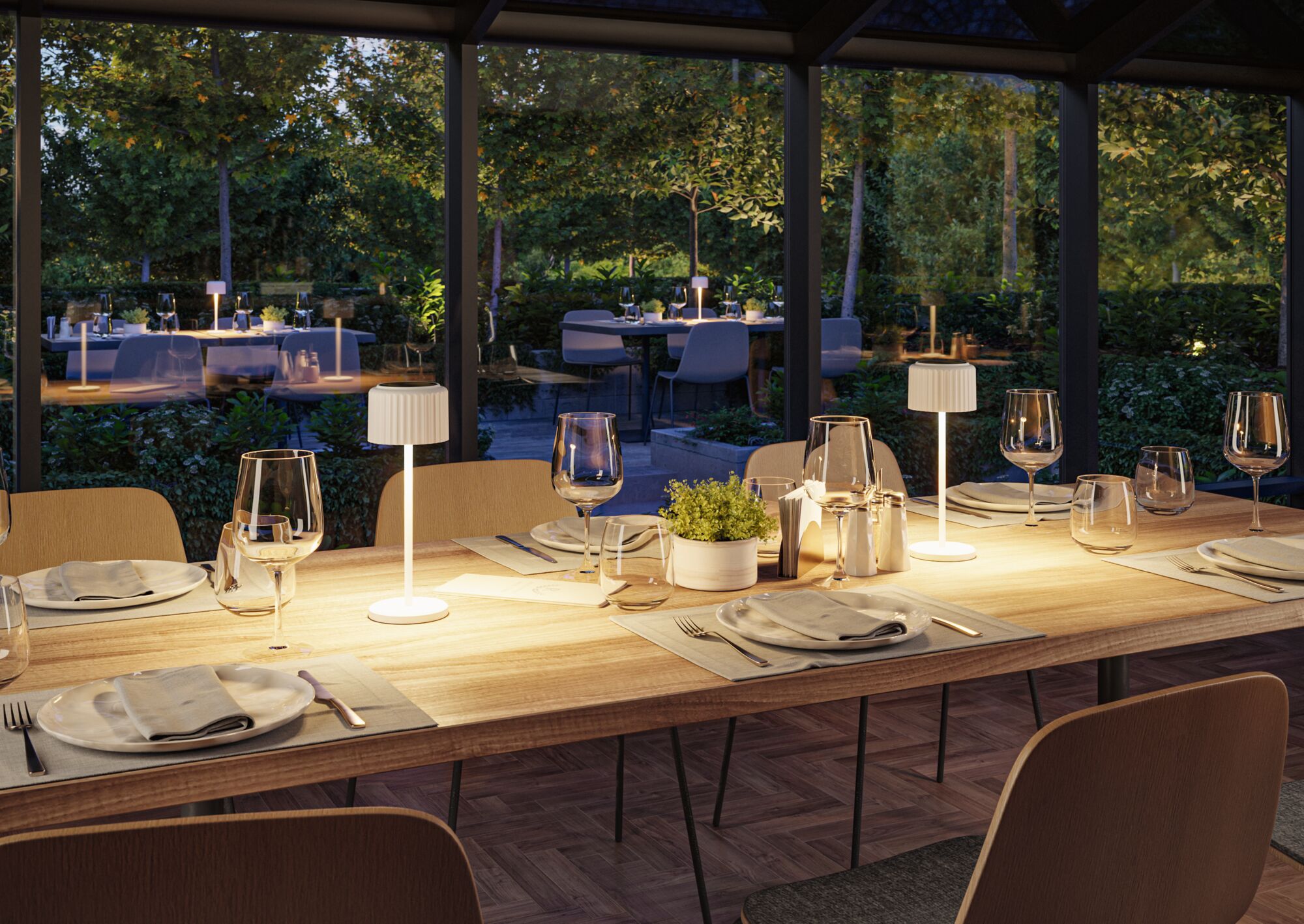 Modern wooden dining table with white LED table lamps in cozy dining room overlooking garden