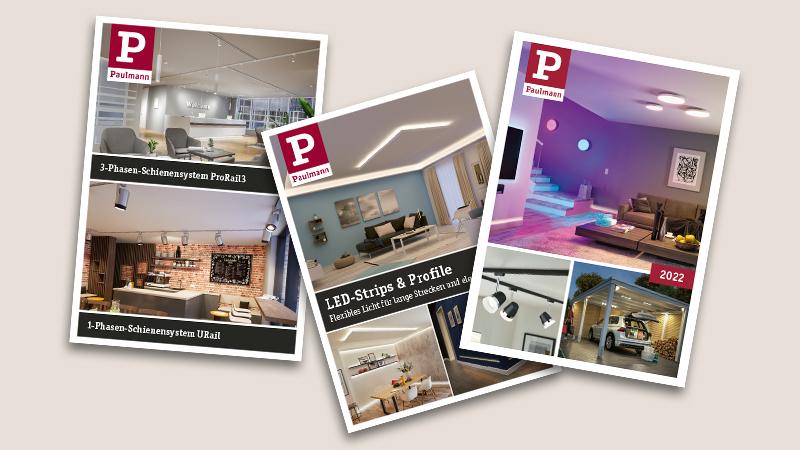 Drei Paulmann Kataloge mit LED-Beleuchtungssystemen und Wohnraumbeleuchtung in modernen Interieurs.