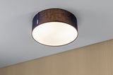 Round ceiling light with black fabric shade and warm white light for modern living spaces