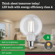 Clear LED bulb with warm white light and ultra-efficient energy use against a green forest background