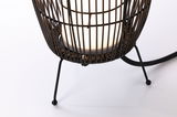 Close-up of black metal stand with woven lampshade and white LED light bulb for modern lighting.