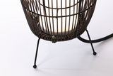 Close-up of black metal stand with woven lampshade and white LED light bulb for modern lighting.