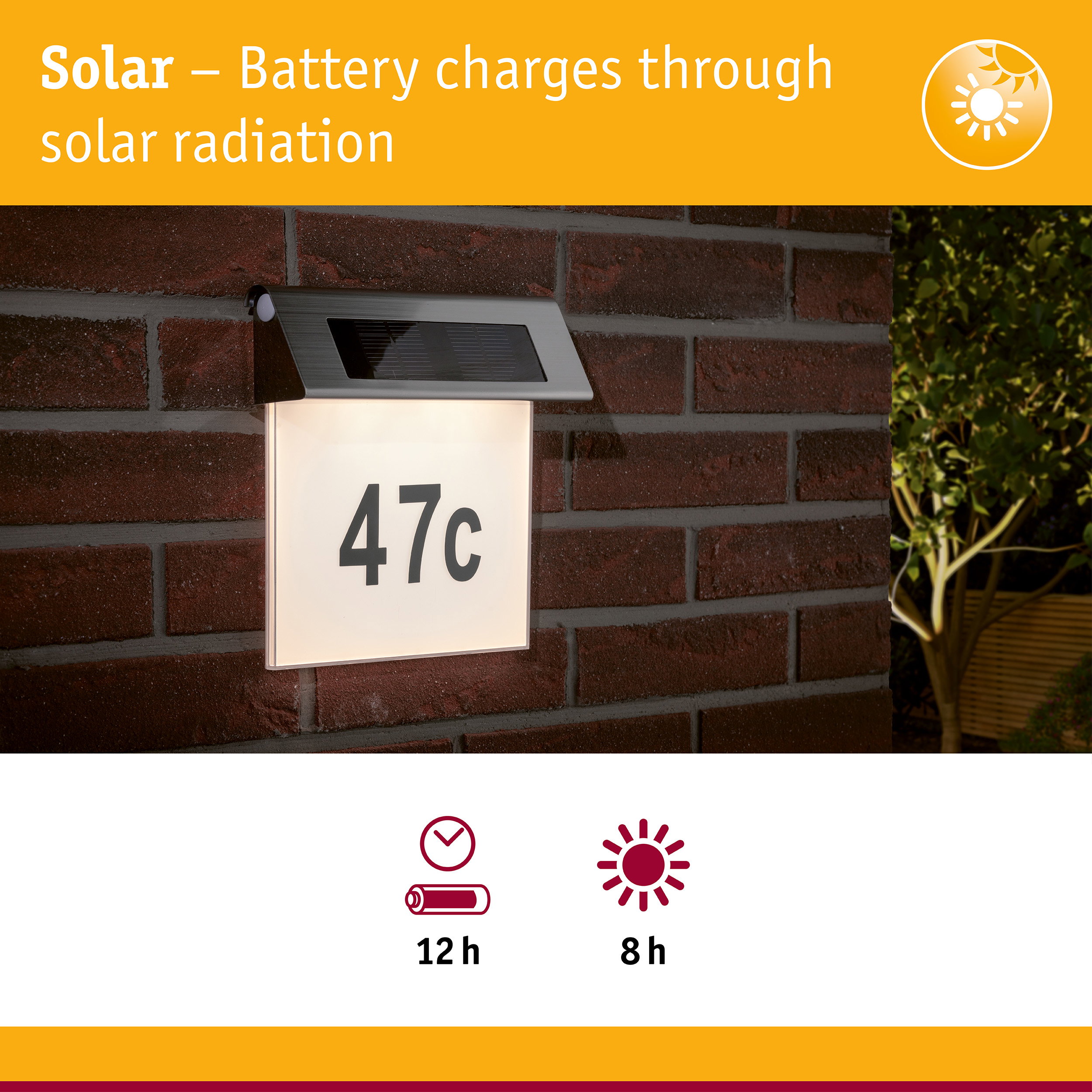 Solar-powered house number light with stainless steel top and white illuminated panel on red brick wall