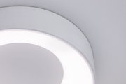 Close-up of white round LED ceiling light with diffused glow and modern minimalist design