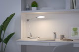 Witte LED-bureaulamp met verstelbare arm op moderne werkplek met laptop en mok