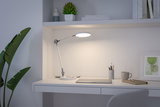 Hvid LED-skrivebordslampe med justerbar arm på moderne arbejdsplads med bærbar og kop