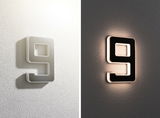Modern house number 9 in grey and black metal with LED lighting for exterior walls